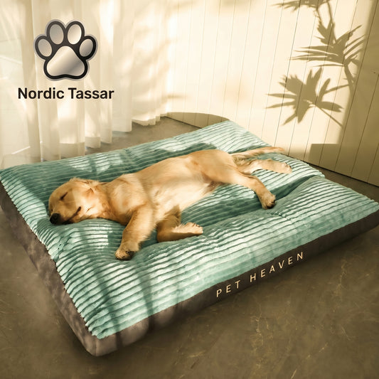 A golden retriever puppy sleeping peacefully on a green Nordic Slumber washable removable bed, branded "Pet Heaven" by Nordic Tassar.