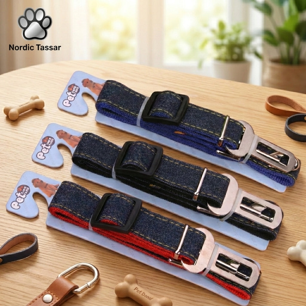 Nordic Safe-Travel collection featuring three cowboy denim dog seat belts in blue, dark denim, and red, displayed on retail packaging on a wooden table.