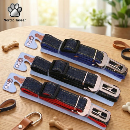 Nordic Safe-Travel collection featuring three cowboy denim dog seat belts in blue, dark denim, and red, displayed on retail packaging on a wooden table.