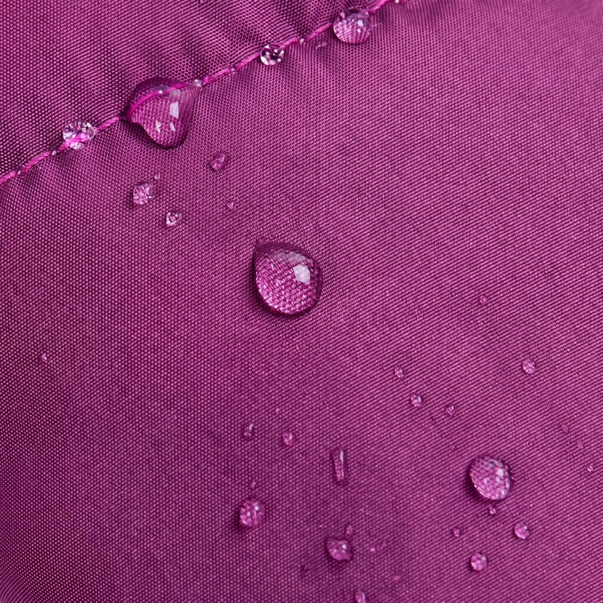 Close-up detail of the PufferGuard Reflex purple waterproof fabric showing water beads for rain resistance.