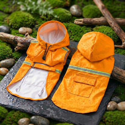 Orange waterproof dog raincoats with reflective strips and hoods, displayed on a natural mossy surface with branches.