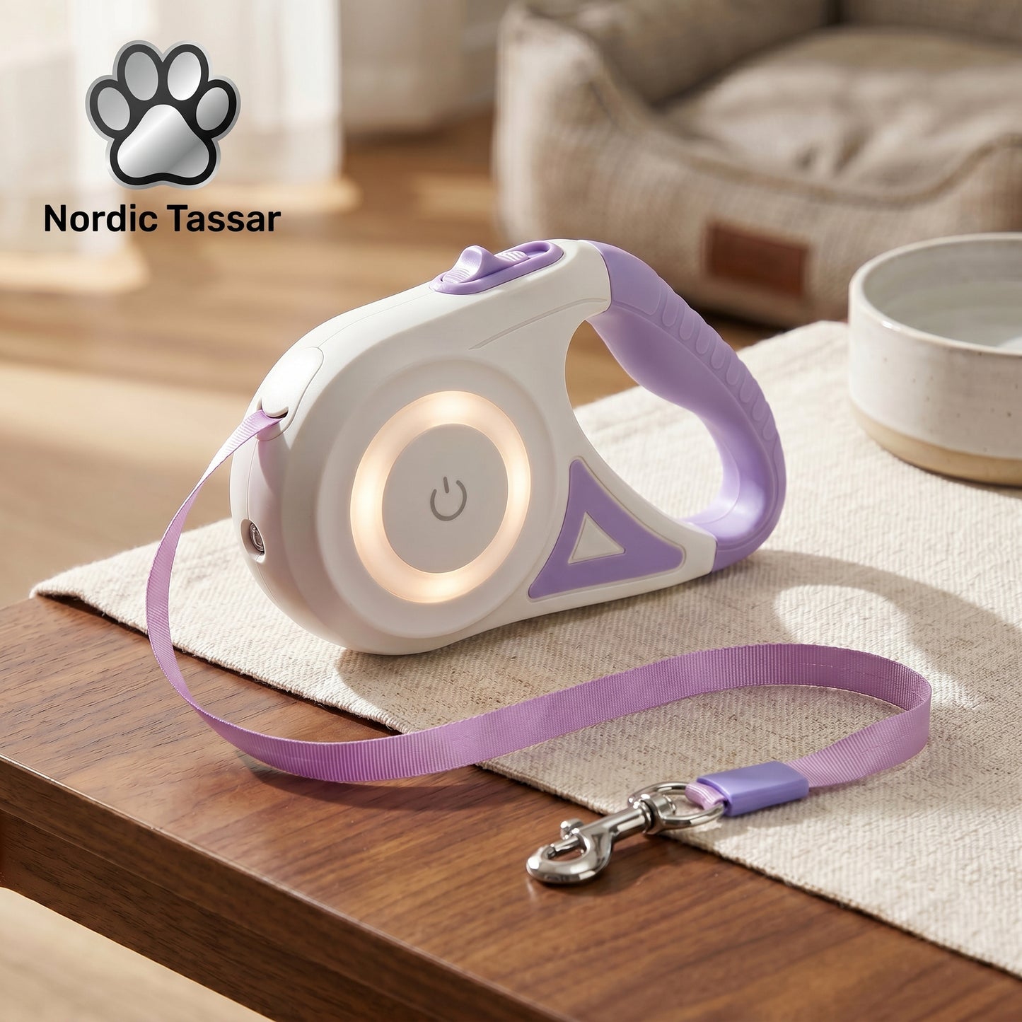Close-up of the SmartWalk 2.0 retractable leash, highlighting the built-in LED light feature and purple circular lighting design, placed on a table.