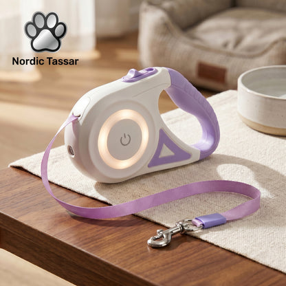 Close-up of the SmartWalk 2.0 retractable leash, highlighting the built-in LED light feature and purple circular lighting design, placed on a table.