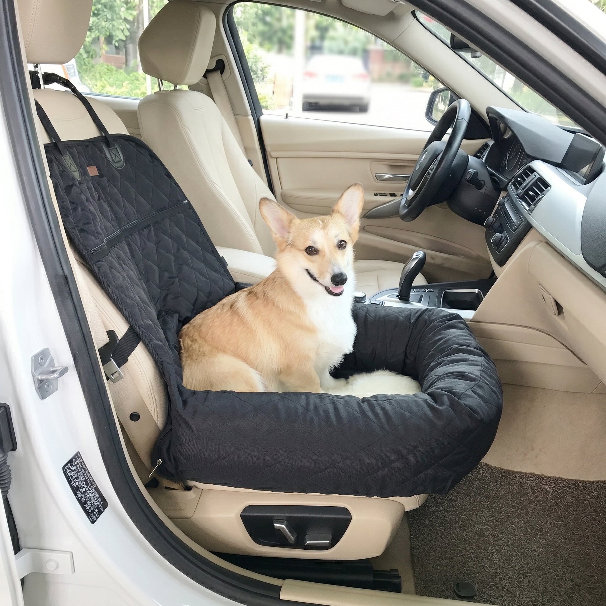 dog sitting comfortably in a Nordic Throne Luxury Car Pet Suite installed in the front seat of a vehicle.